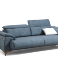 a blue couch with a pillow on top of it