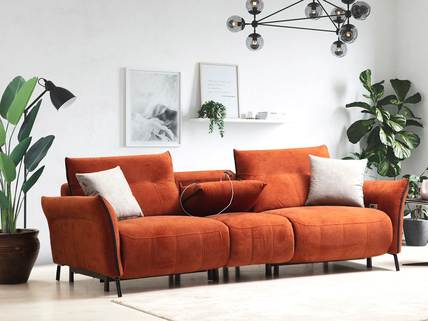 a living room with an orange couch and potted plants