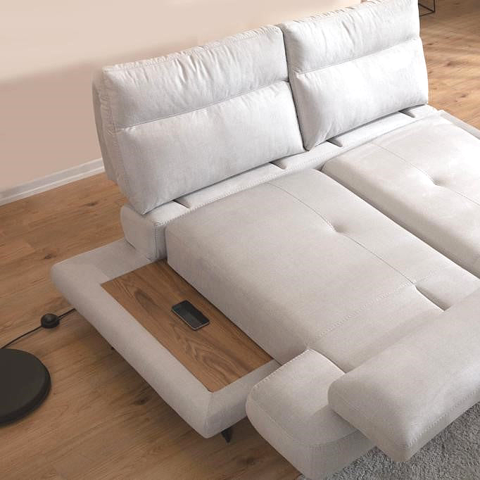 a white couch with a wooden coffee table on top of it