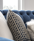 a blue couch with a white fluffy pillow