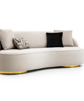 a white couch with black and gold pillows