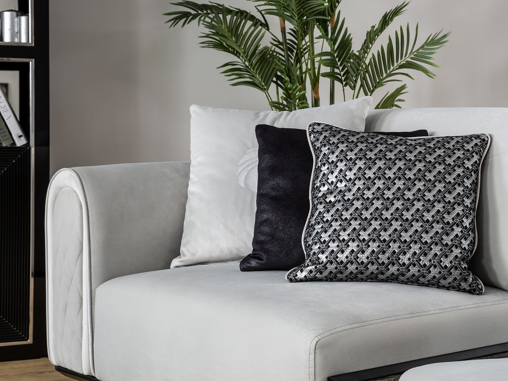 a white couch with black and white pillows