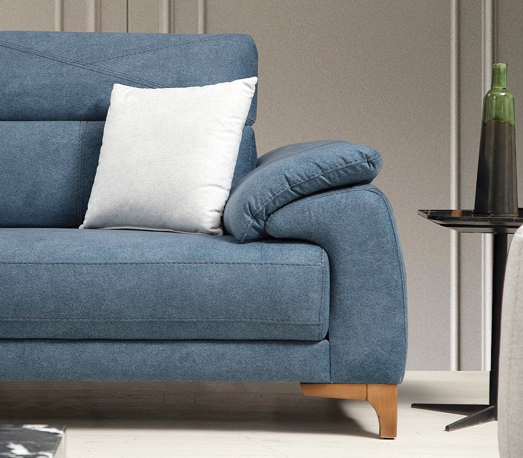 a blue couch with two white pillows on it