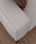 a close up of a white couch on a wooden floor