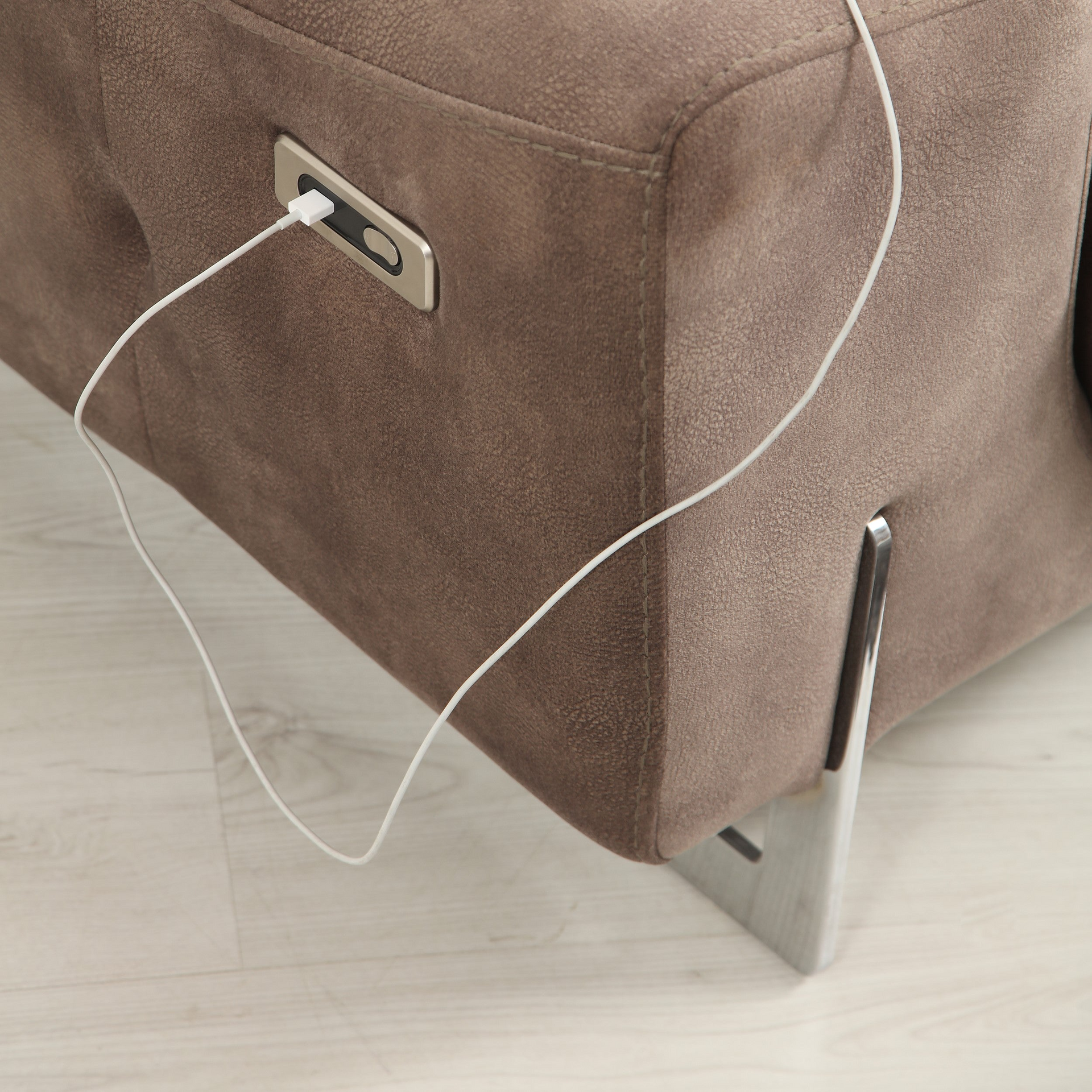 a close up of a couch with a cord attached to it