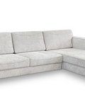 a white couch with a footstool and ottoman