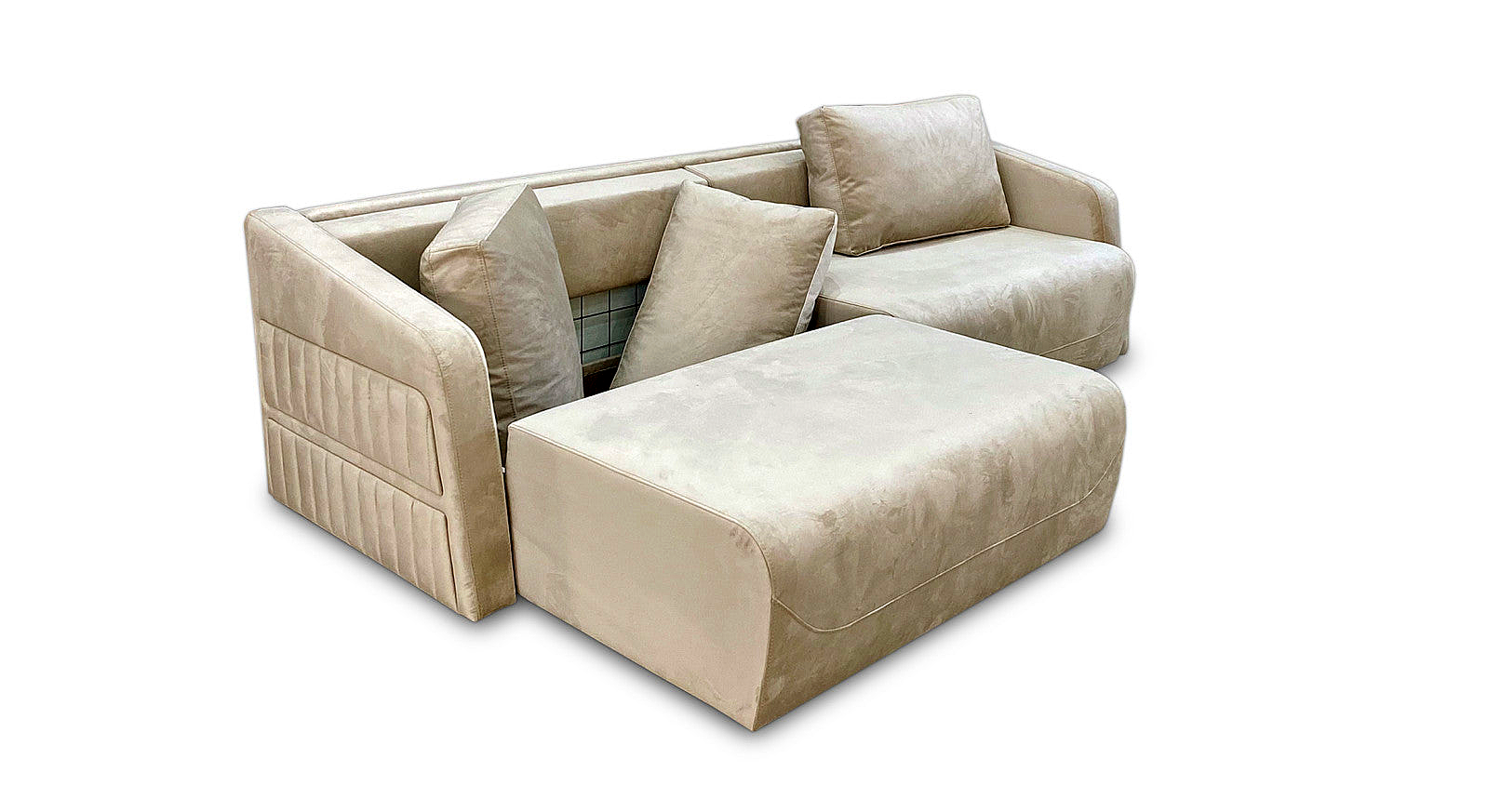 a couch with a footstool and pillows on it