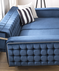 a blue couch with a black and white pillow on it