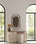 a room with arched windows, a dresser and a mirror