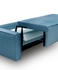 a blue couch with a pull out bed underneath it