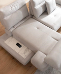 a couch with a recliner and a remote control