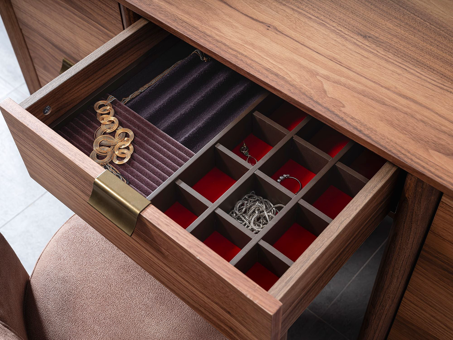 a wooden desk with a drawer full of jewelry