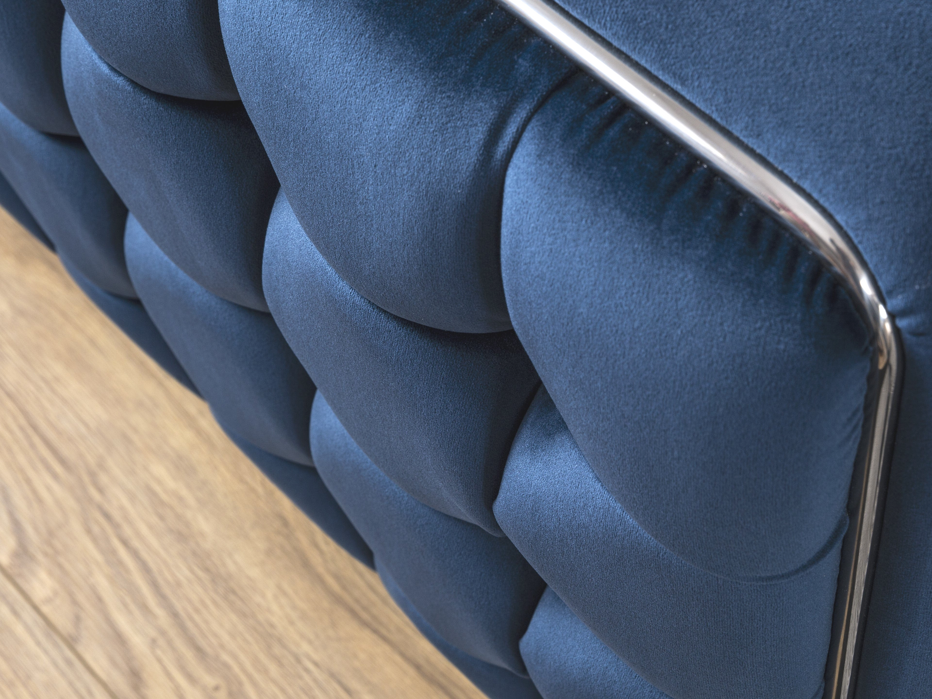 a close up of a blue upholstered bed frame