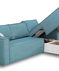 a blue couch with a white ottoman underneath it