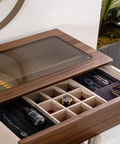 a wooden desk with a drawer containing watches and watches