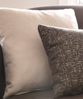 a close up of some pillows on a couch