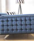 a blue couch sitting on top of a wooden floor