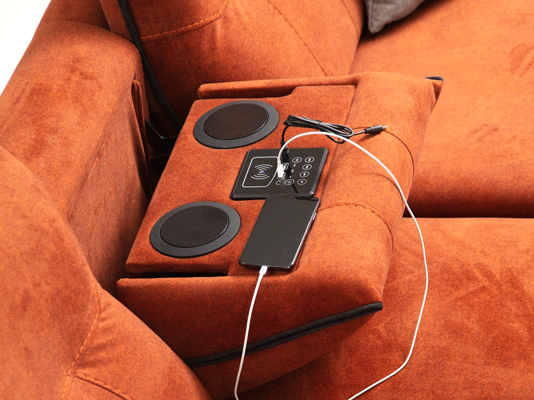 a couch with speakers and a remote control