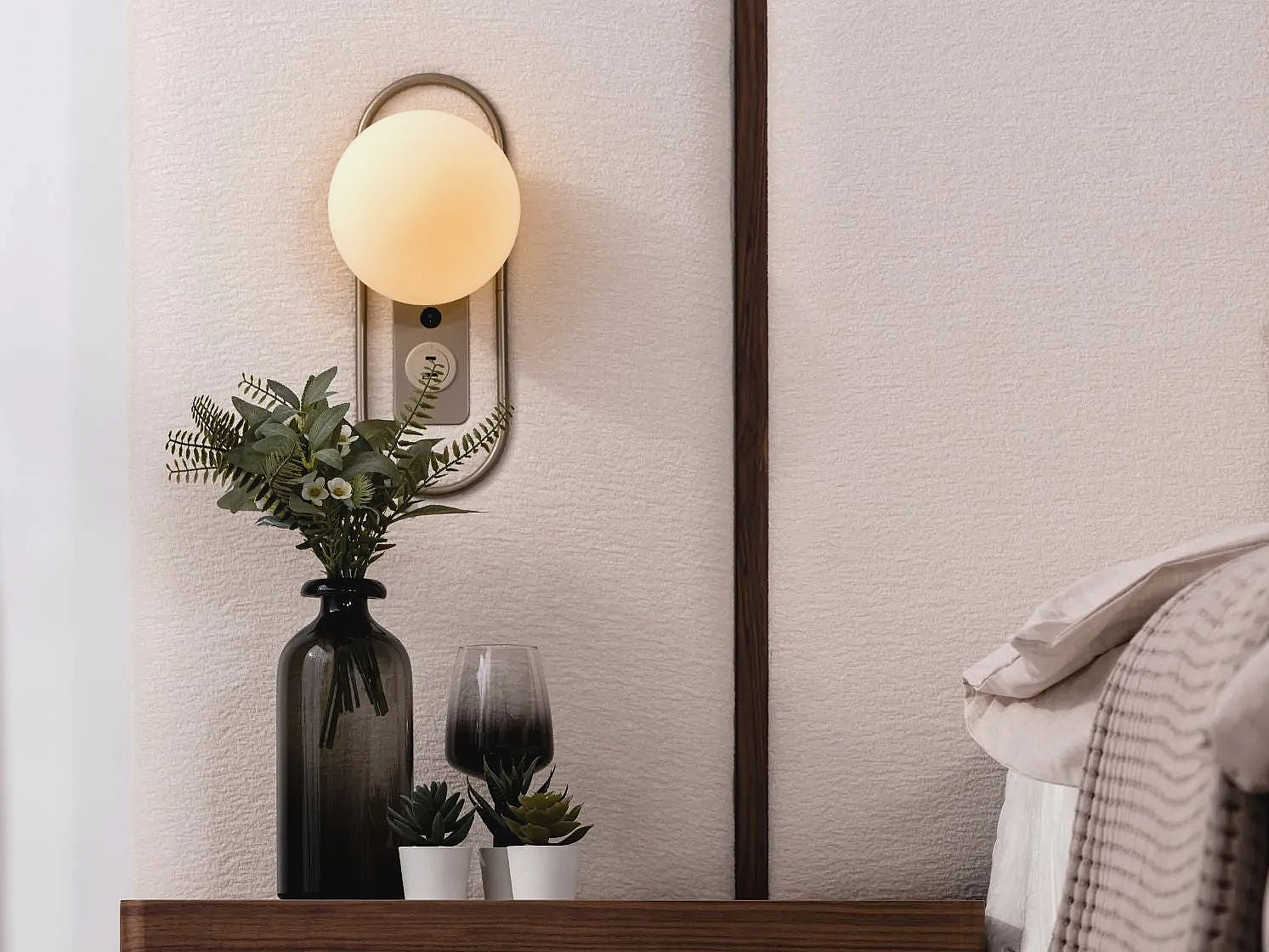 a lamp that is on a wall next to a bed